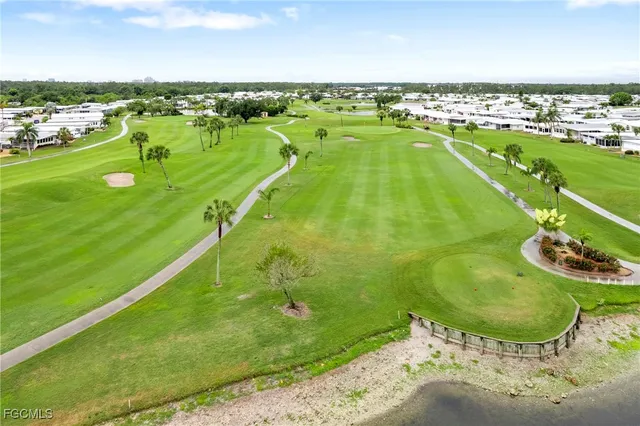 an aerial view of residential houses with outdoor space and swimming pool