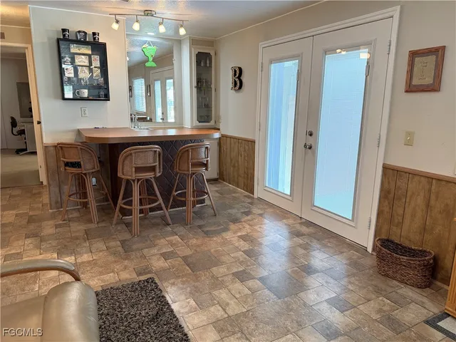 a view of a dining room with furniture and a chandelier