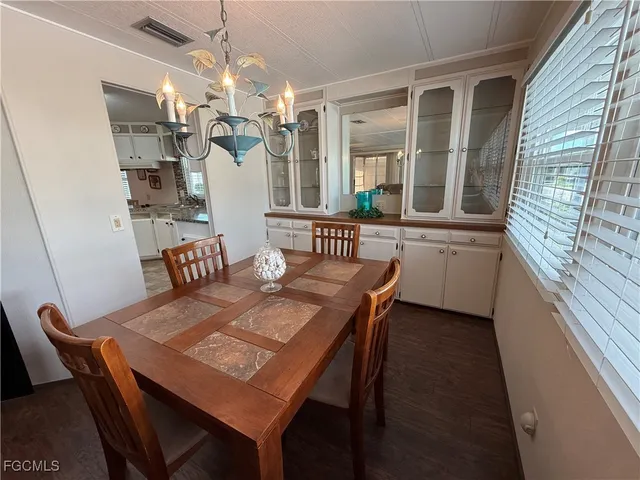 a view of a dining room with furniture and a chandelier