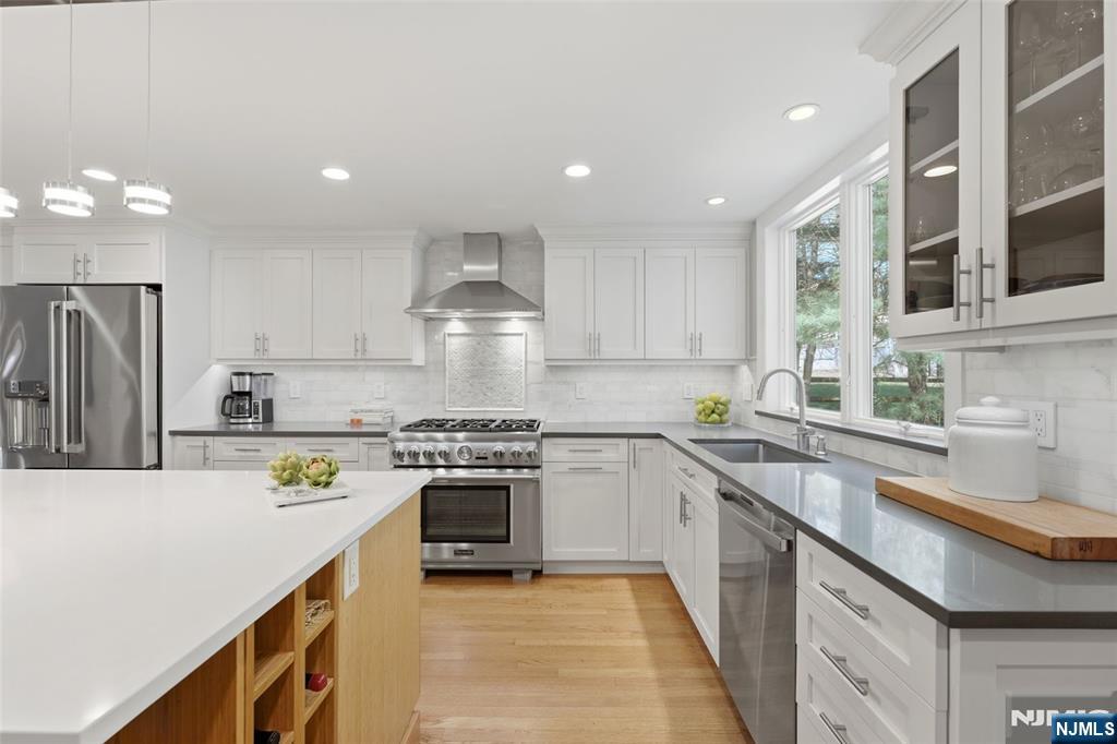89 Surrey Lane Tenafly, NJ 07670 - Photo 11 of 49 a kitchen with a sink a stove a refrigerator and cabinets