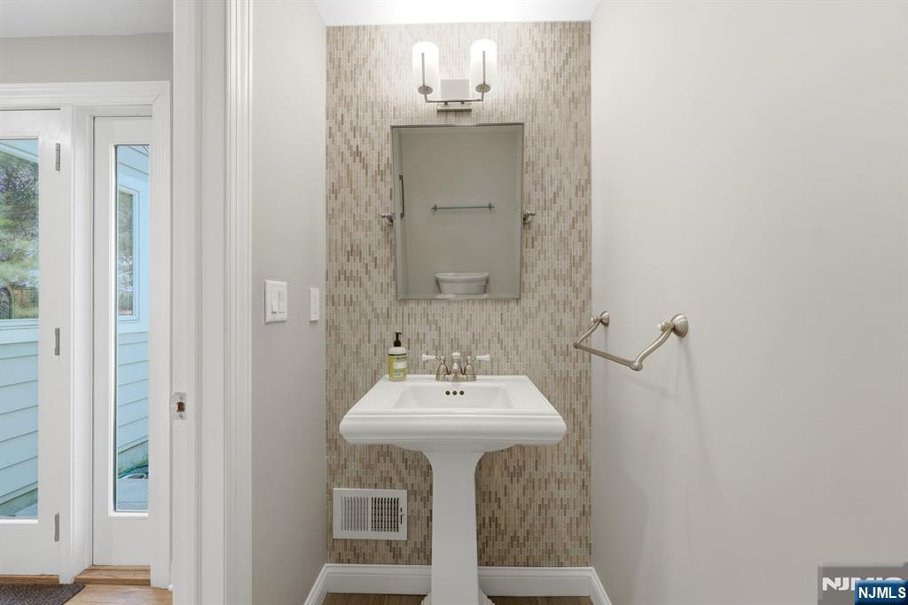 89 Surrey Lane Tenafly, NJ 07670 - Photo 18 of 49 a bathroom with a sink and a mirror