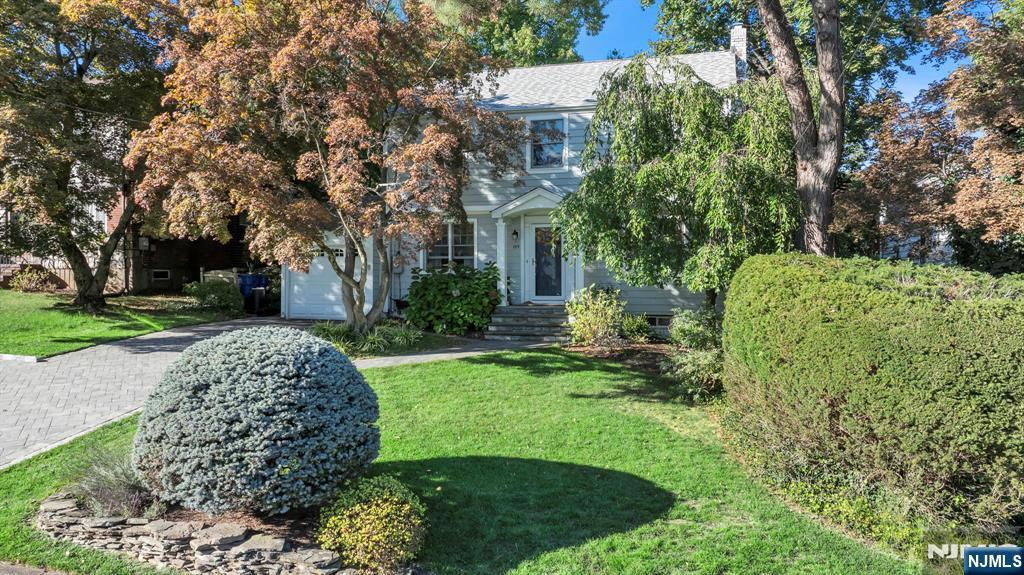 89 Surrey Lane Tenafly, NJ 07670 - Photo 2 of 49 a view of a house with a tree and plants