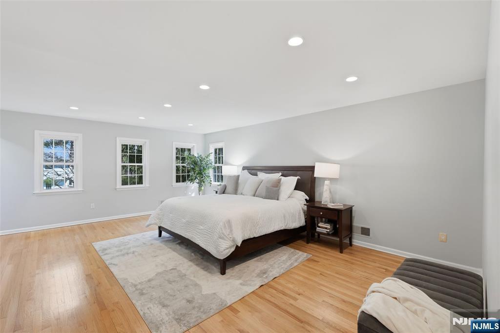 89 Surrey Lane Tenafly, NJ 07670 - Photo 27 of 49 a bedroom with a bed and a night stand