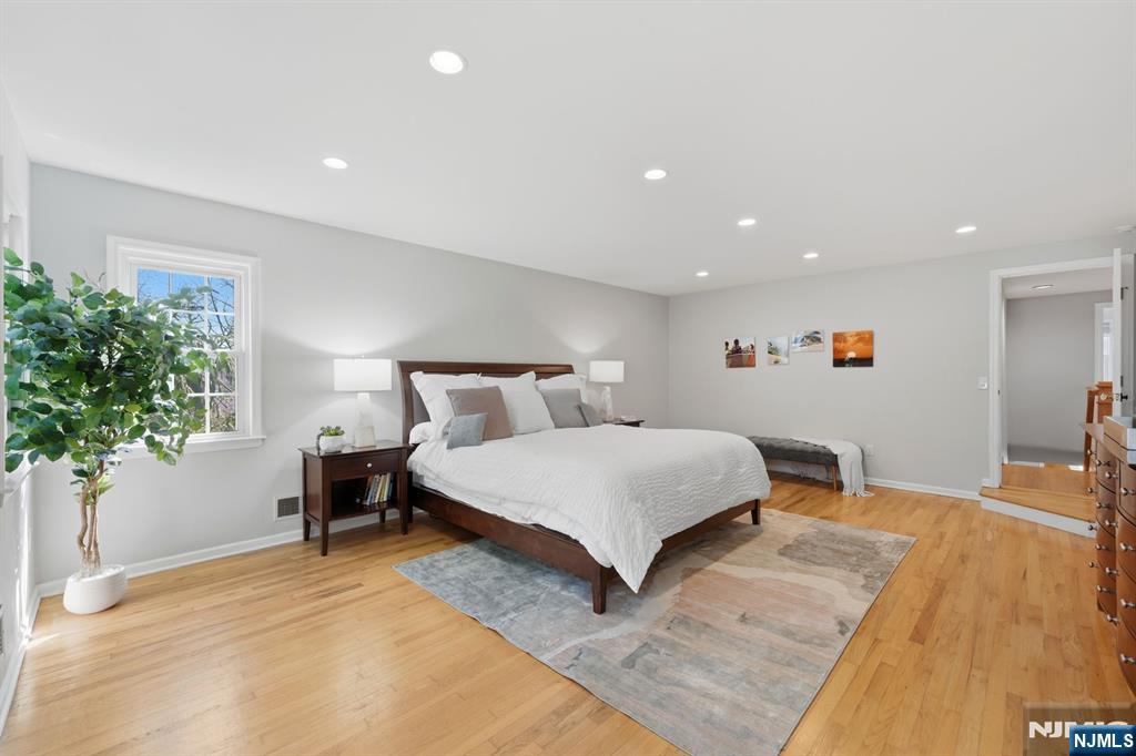 89 Surrey Lane Tenafly, NJ 07670 - Photo 29 of 49 a bedroom with a bed and a potted plant