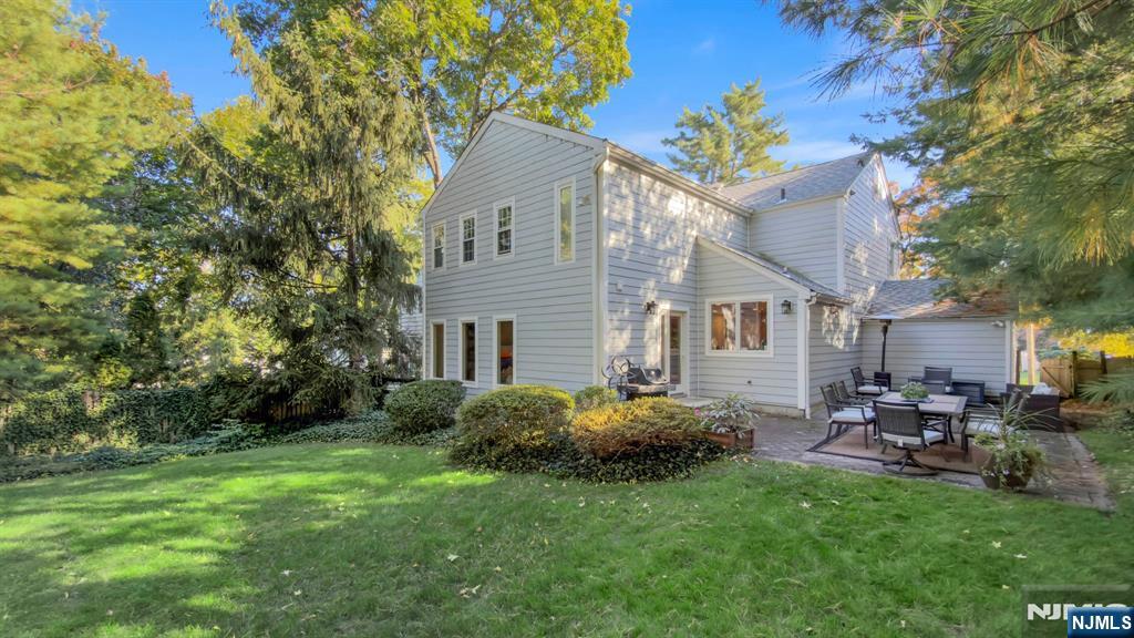 89 Surrey Lane Tenafly, NJ 07670 - Photo 3 of 49 a backyard of a house with table and chairs