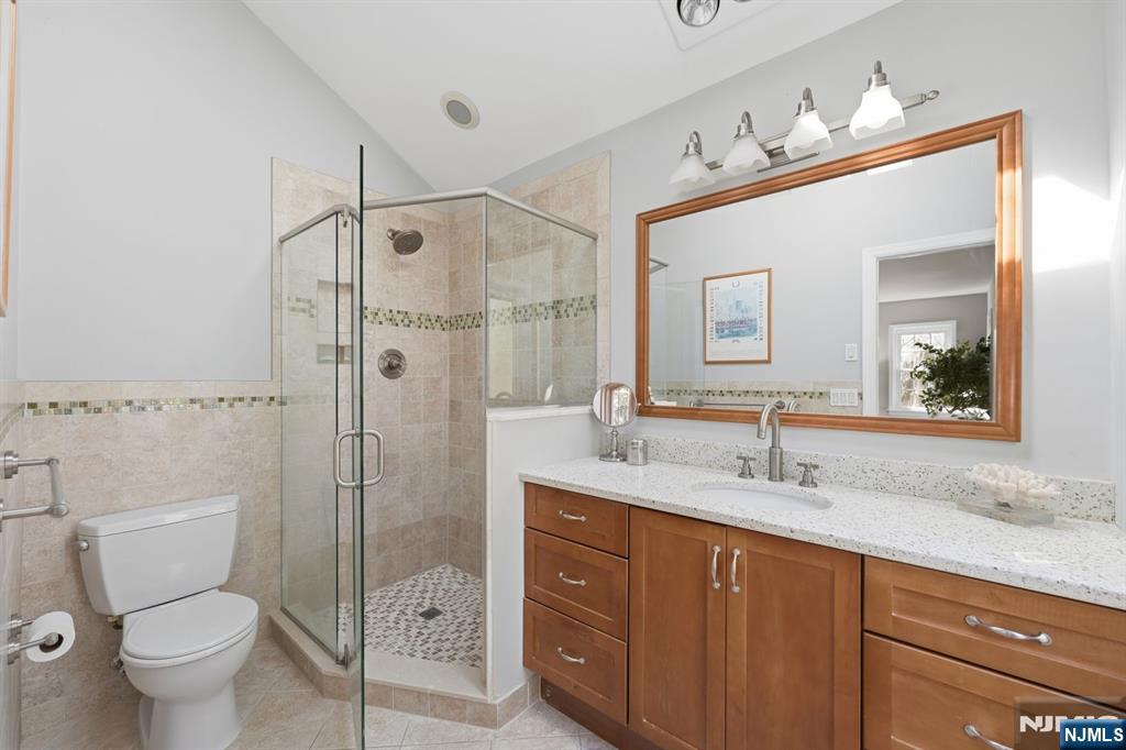 89 Surrey Lane Tenafly, NJ 07670 - Photo 31 of 49 a bathroom with a granite countertop sink mirror shower and toilet