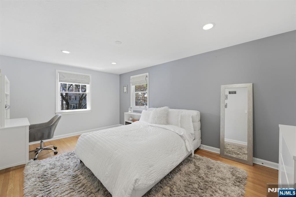 89 Surrey Lane Tenafly, NJ 07670 - Photo 33 of 49 a bedroom with a bed and wooden floor