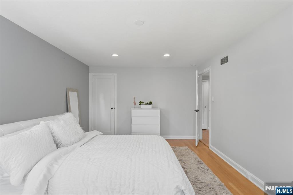 89 Surrey Lane Tenafly, NJ 07670 - Photo 34 of 49 a bedroom with a bed and a mirror