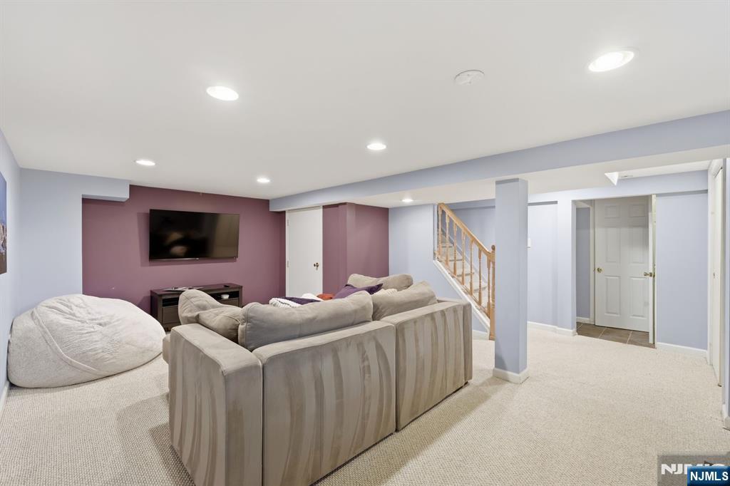 89 Surrey Lane Tenafly, NJ 07670 - Photo 41 of 49 a living room with furniture and a flat screen tv