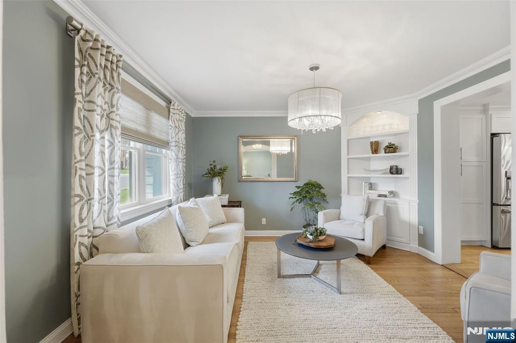 89 Surrey Lane Tenafly, NJ 07670 - Photo 7 of 49 a living room with furniture and a chandelier