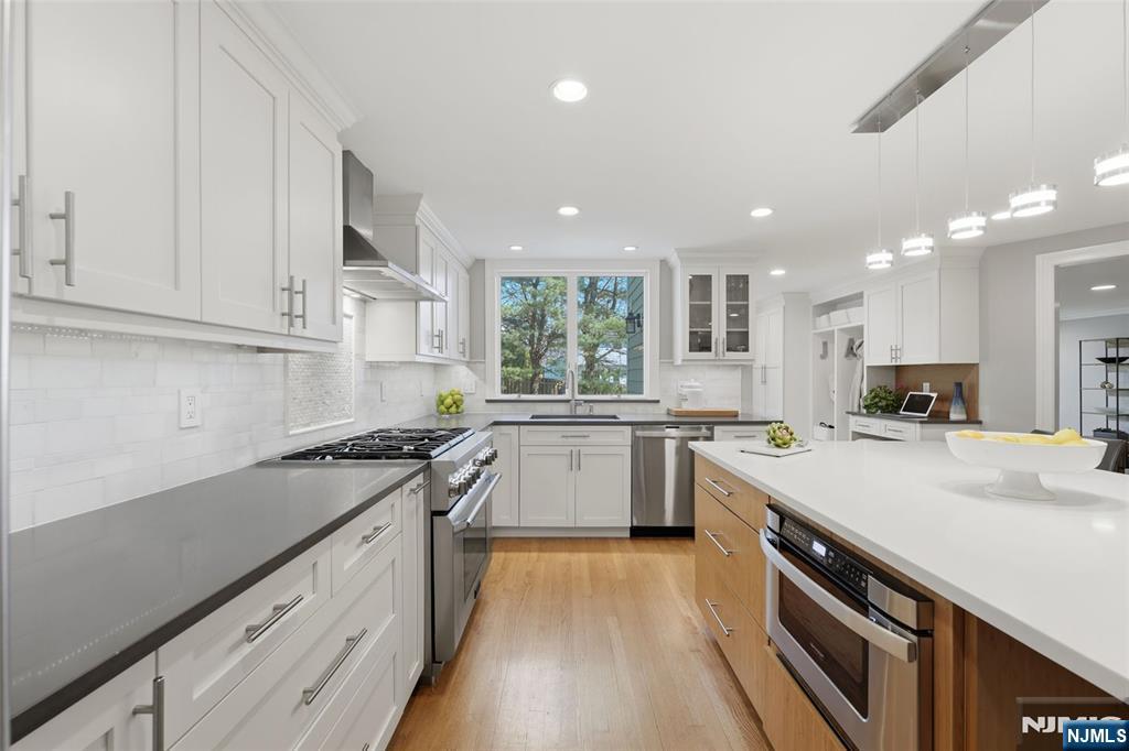 89 Surrey Lane Tenafly, NJ 07670 - Photo 10 of 49 a kitchen with a sink stove and cabinets