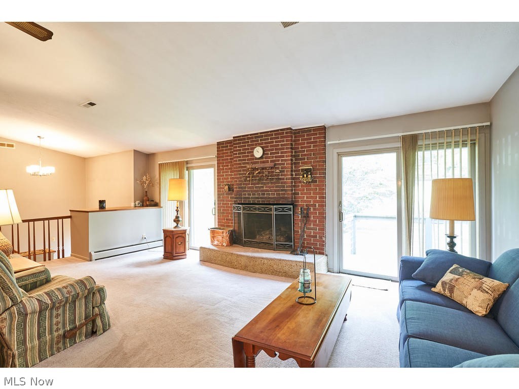 855 Old Spring Road Akron, OH 44321 - Photo 2 of 30 Living room with fireplace and sliders to deck