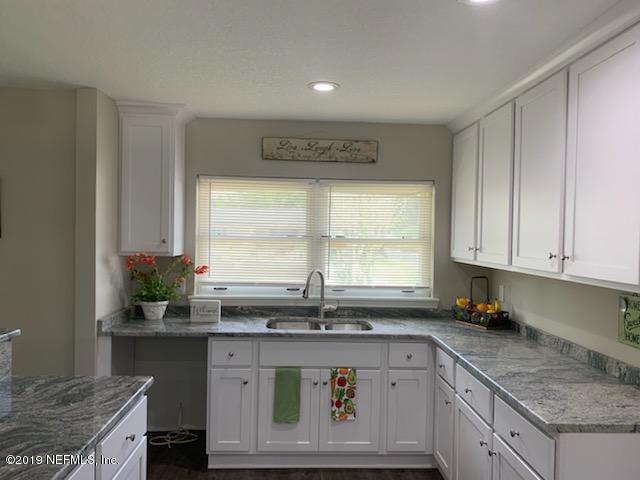 2550 Gayland Road Jacksonville, FL 32218 - Photo 3 of 6 a kitchen with a sink stove and cabinets