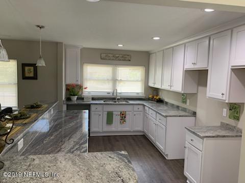 2550 Gayland Road Jacksonville, FL 32218 - Photo 4 of 6 a kitchen with a sink stove and cabinets