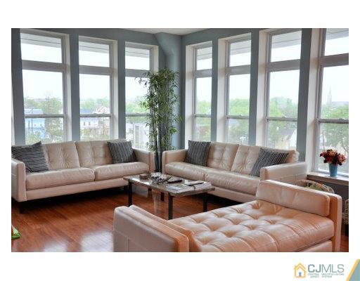 358 Rector Street, Unit STREET 703 Perth Amboy, NJ 08861 - Photo 2 of 10 a living room with furniture and a large window