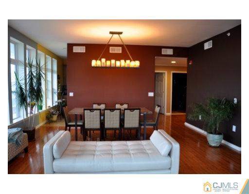 358 Rector Street, Unit STREET 703 Perth Amboy, NJ 08861 - Photo 3 of 10 a living room with furniture and a chandelier