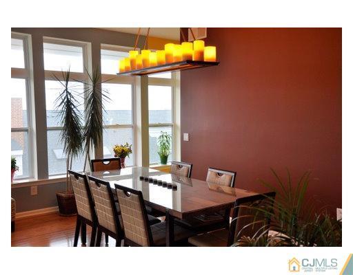 358 Rector Street, Unit STREET 703 Perth Amboy, NJ 08861 - Photo 5 of 10 a dining room with a table and chairs next to a window