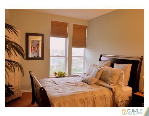 358 Rector Street, Unit STREET 703 Perth Amboy, NJ 08861 - Photo 8 of 10 a bedroom with a bed and a window