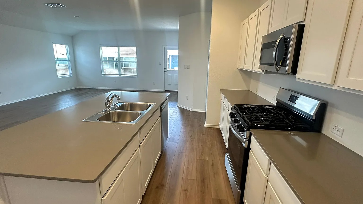 121 Tofalla Kyle, TX 78640 - Photo 6 of 37 a kitchen with a sink a stove and cabinets