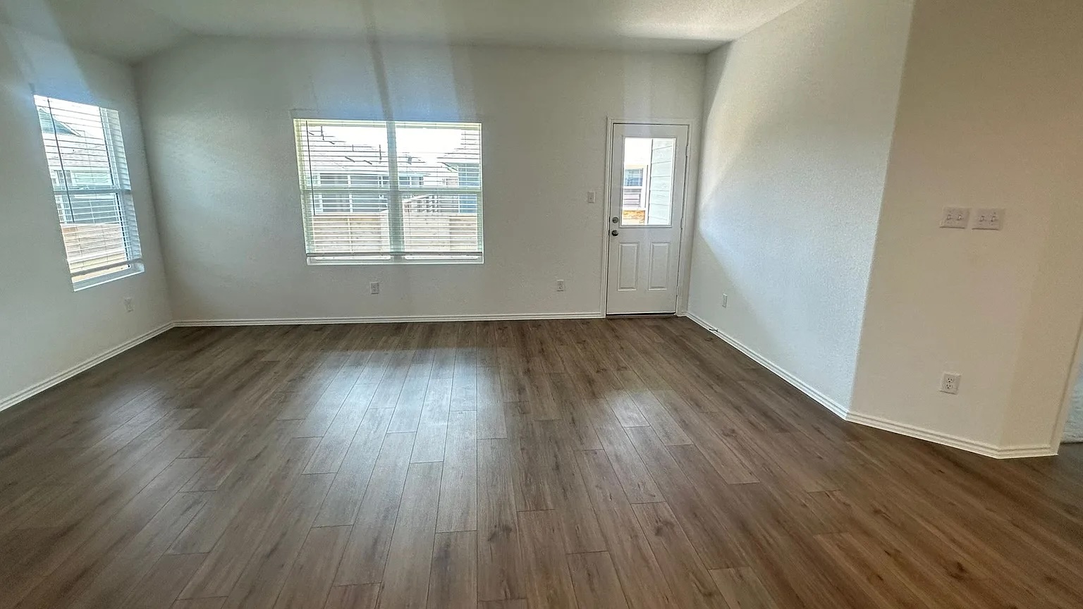 121 Tofalla Kyle, TX 78640 - Photo 9 of 37 an empty room with wooden floor and windows