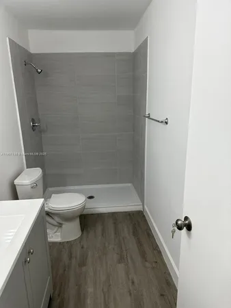 an empty room with wooden floor and closet