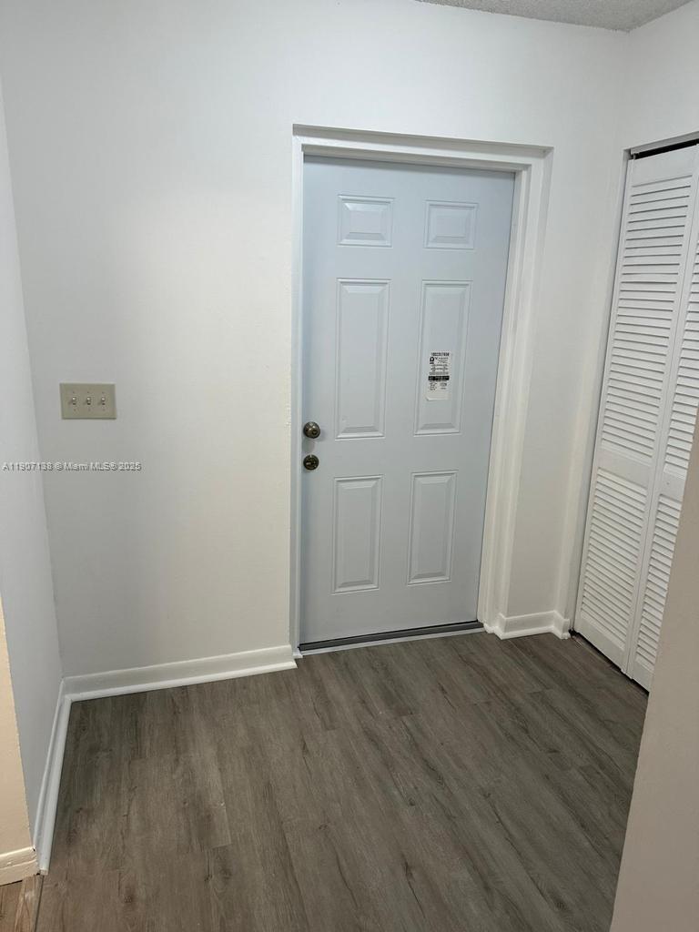 2259 Linton Ridge Circle, Unit G4 Delray Beach, FL 33444 - Photo 17 of 25 an empty room with wooden floor and closet