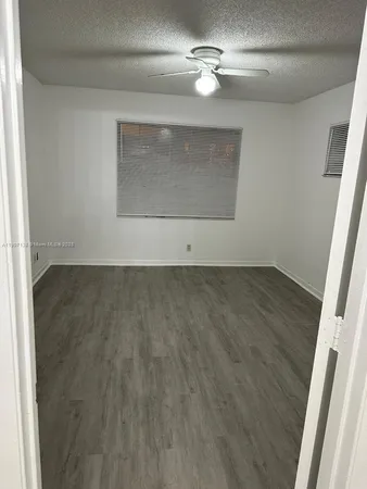 a view of a room with wooden floor