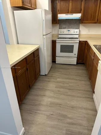 a kitchen with a refrigerator stove and a sink