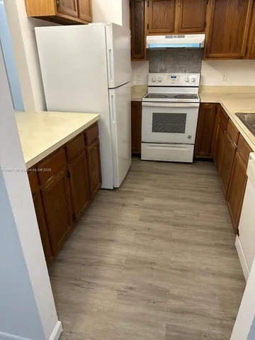 a kitchen with a refrigerator stove and a sink
