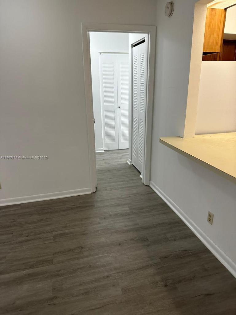2259 Linton Ridge Circle, Unit G4 Delray Beach, FL 33444 - Photo 8 of 25 a view of an empty room with wooden floor and a window