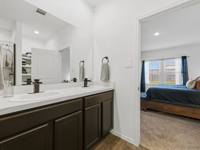 a spacious bedroom with a bed and a window