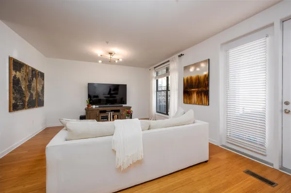 a view of a workspace with furniture and wooden floor