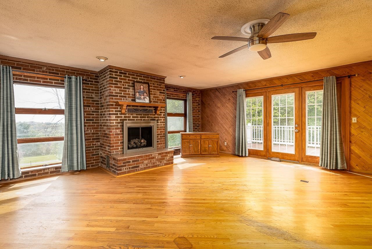 2833 Shutterlee Mill Road Staunton, VA 24401 - Photo 13 of 70 a view of an empty room with a fireplace and a window