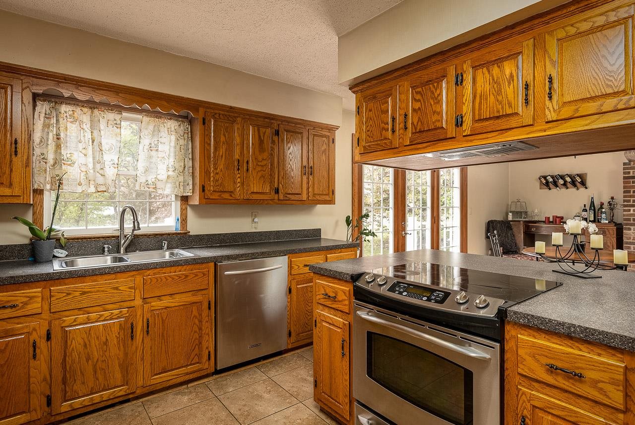 2833 Shutterlee Mill Road Staunton, VA 24401 - Photo 19 of 70 a kitchen with stainless steel appliances granite countertop a stove sink and cabinets