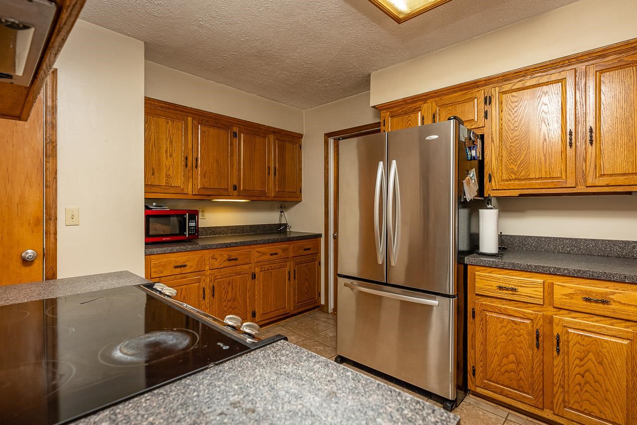 2833 Shutterlee Mill Road Staunton, VA 24401 - Photo 20 of 70 a kitchen with stainless steel appliances granite countertop a refrigerator sink and stove