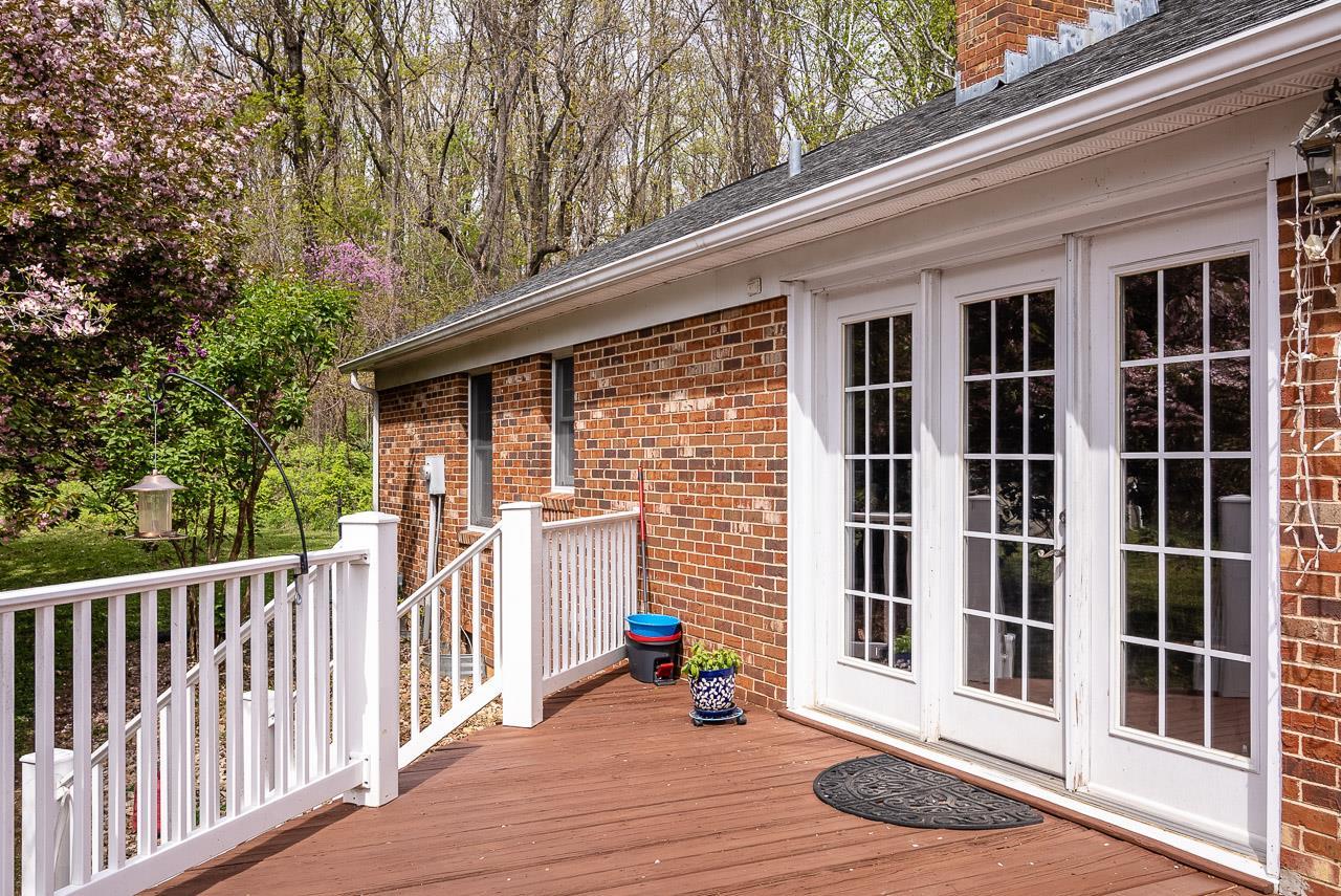 2833 Shutterlee Mill Road Staunton, VA 24401 - Photo 51 of 70 a view of a balcony with wooden floor and fence and a floor to ceiling window