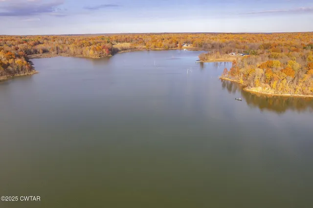 an aerial view of a house with a lake view