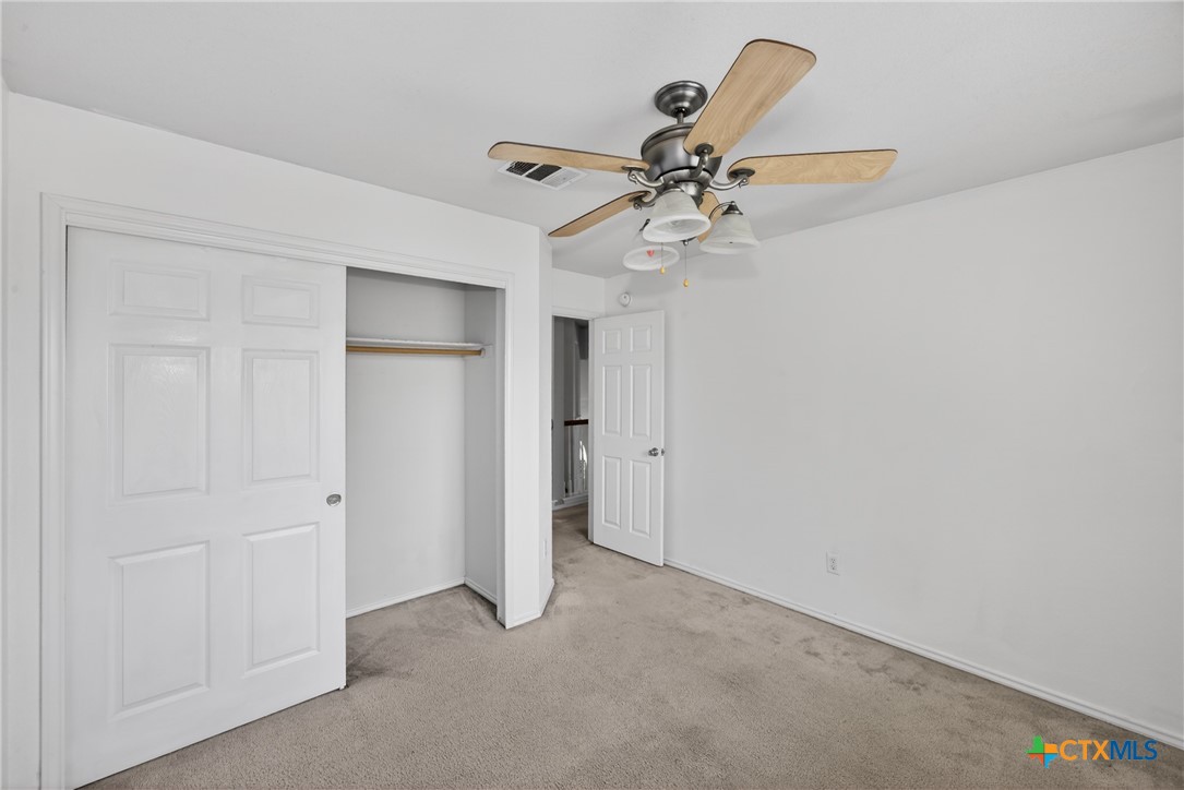 7015 Rickey Drive Temple, TX 76502 - Photo 19 of 29 an empty room with closet and a chandelier fan