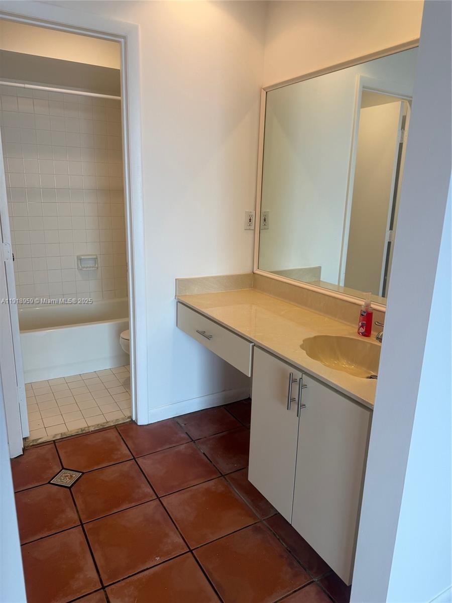 13773 Southwest 147th Cir Lane, Unit 121 Miami, FL 33186 - Photo 15 of 16 a bathroom with a sink and a mirror