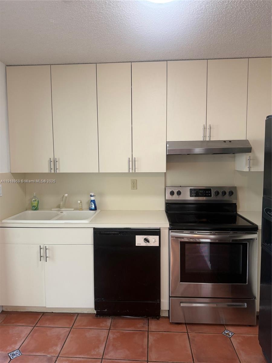 13773 Southwest 147th Cir Lane, Unit 121 Miami, FL 33186 - Photo 6 of 16 a stove top oven sitting inside of a kitchen