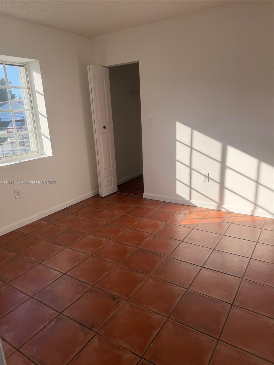 13773 Southwest 147th Cir Lane, Unit 121 Miami, FL 33186 - Photo 10 of 16 a view of an empty room with a window