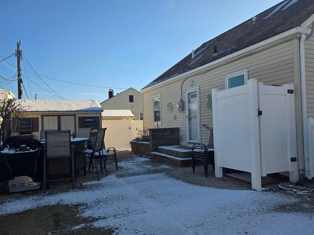 a view of a patio with table and chairs