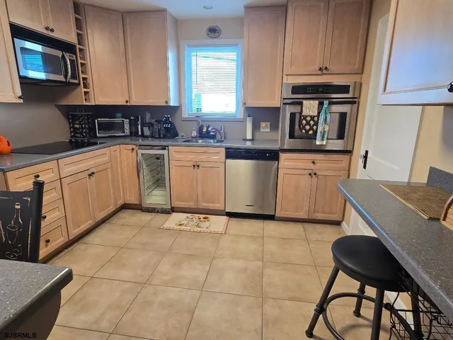 a kitchen with stainless steel appliances granite countertop a stove a sink a microwave and a refrigerator