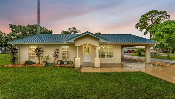 a front view of a house with a yard porch and furniture