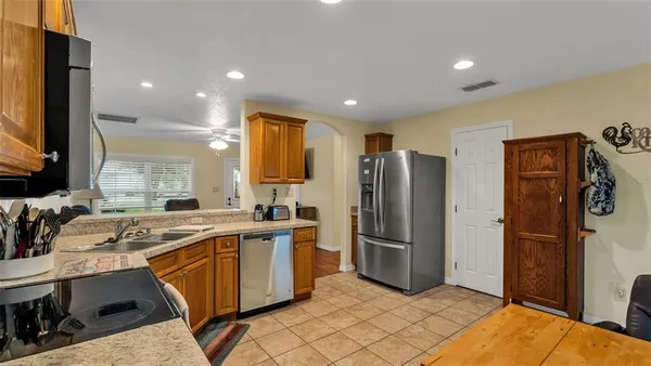 a bathroom with a granite countertop sink toilet a mirror and shower