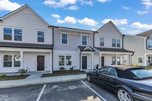 a front view of a house with parking space
