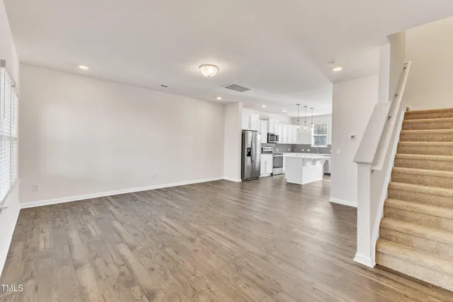 a view of a kitchen with wooden floor and electronic appliances