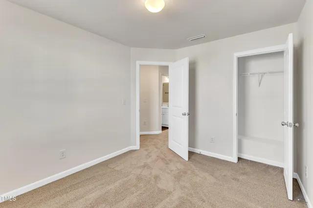 a view of a room with wooden floor and windows