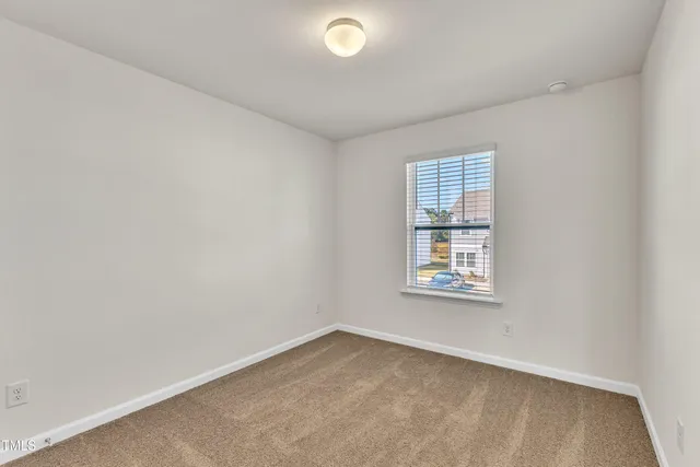 a front view of a building with a garden