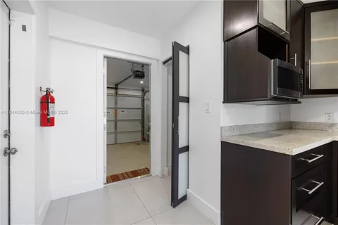 a kitchen with a refrigerator and a sink